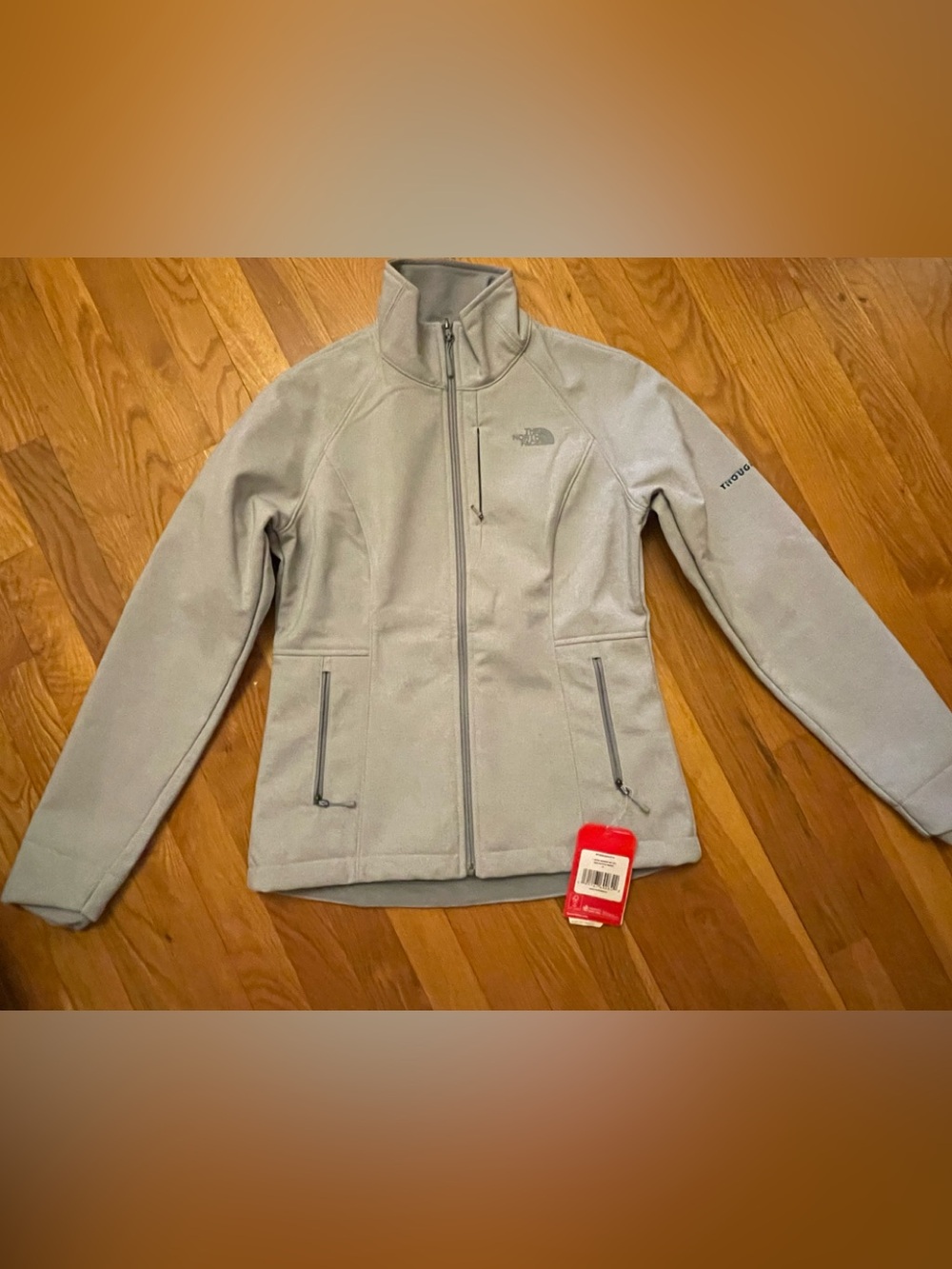 The North Face Women’s Apex Bionic Light Gray Jacket with company logo